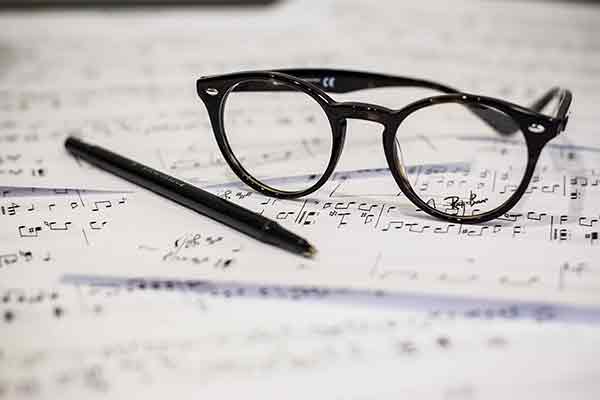 sheet music with pen and glasses